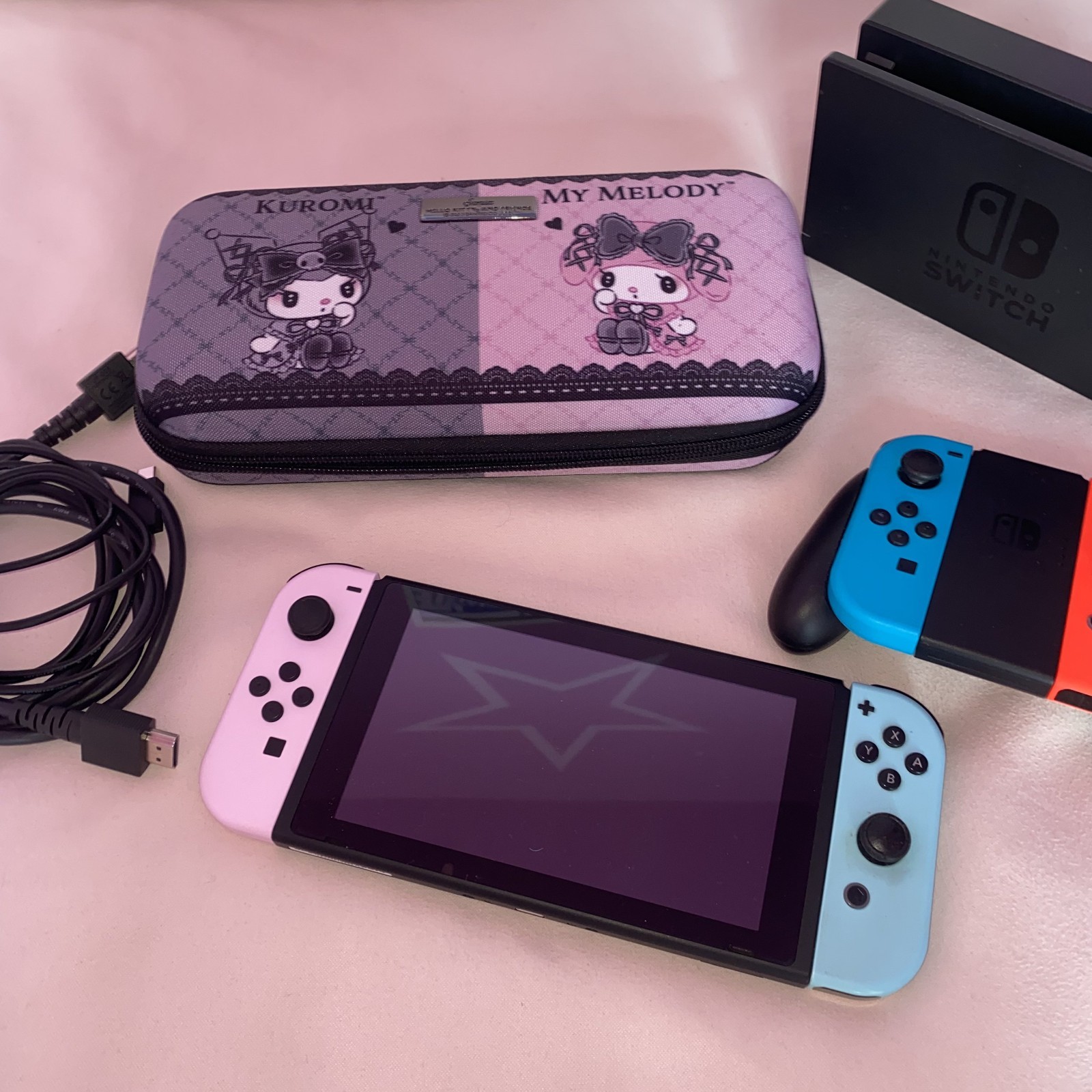 Nintendo Switch with additional Sanrio case and baby pink and blue joycons