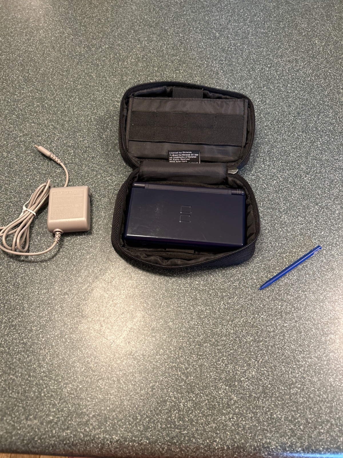 DS Lite includes charger, stylus, and case but game not included