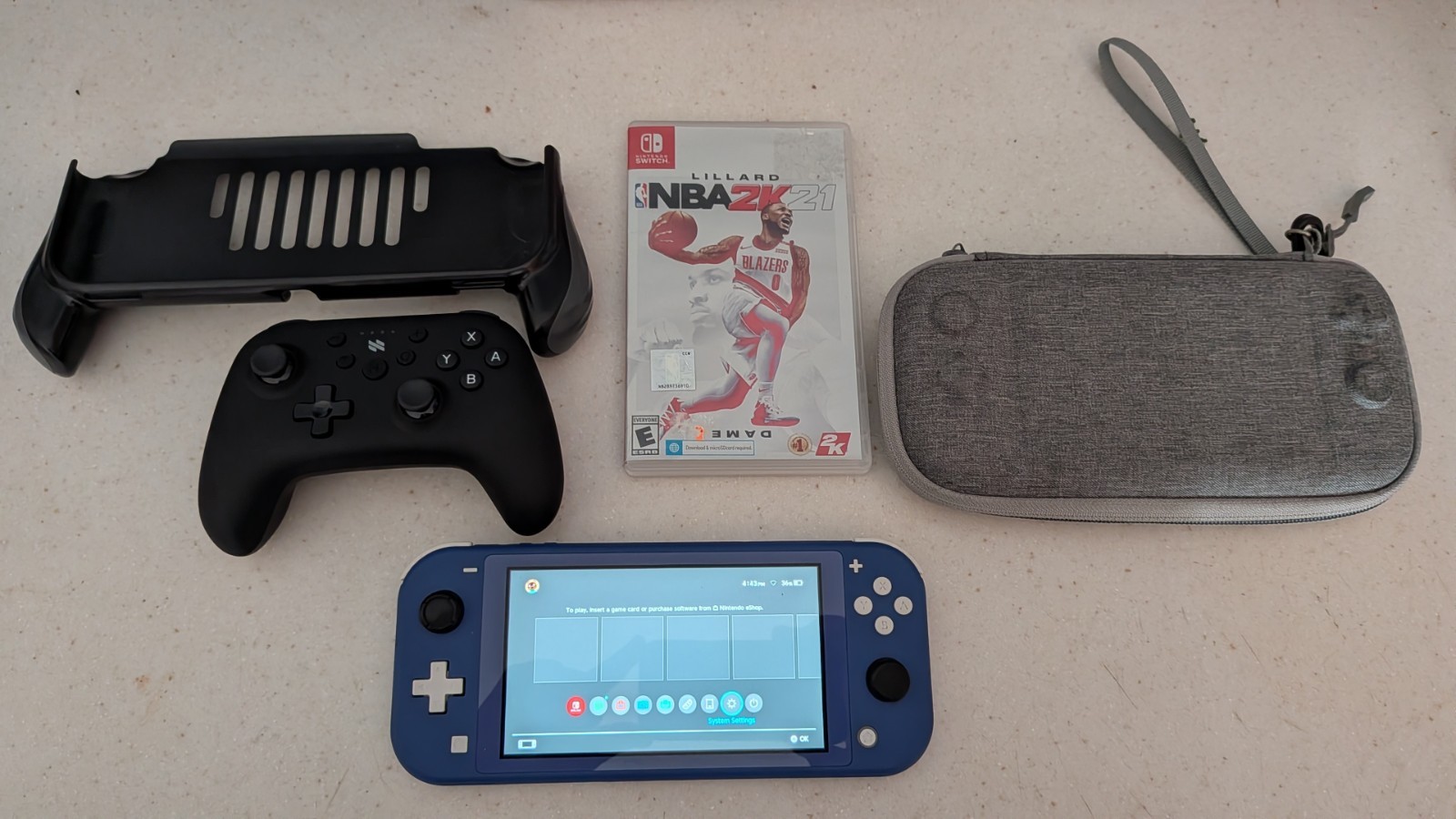 Nintendo Switch Lite – Blue With Hard Case, 1 Game, Bluetooth Controller & Grip