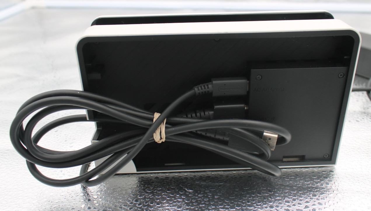 Nintendo Switch OLED Console 64GB w/ dock, cords, and JC holder *factory reset