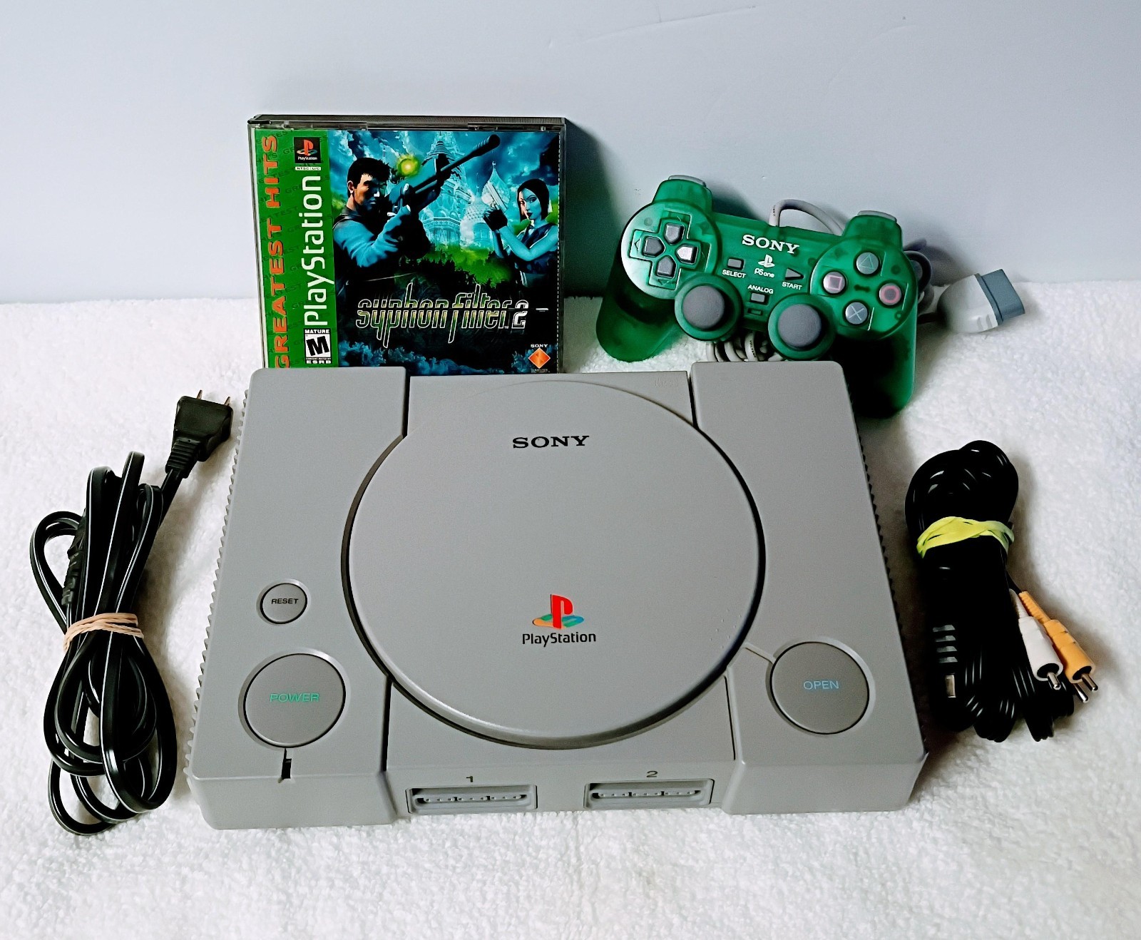 Playstation 1 with 1 controller, AV Cable, power cable and Syphon Filter 2 game